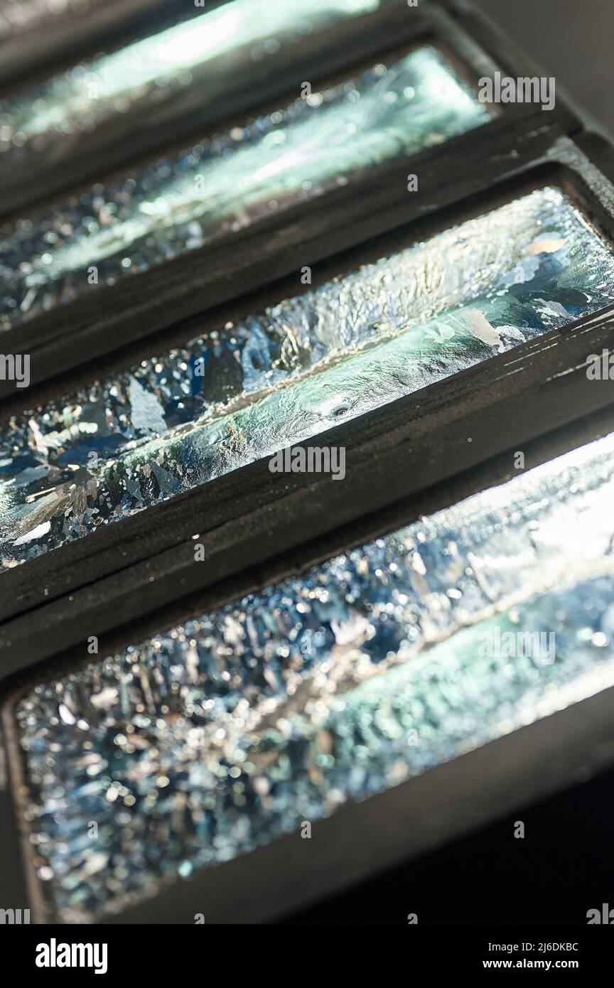Biscuit of shiny silver cools down in graphite casting form Stock Photo