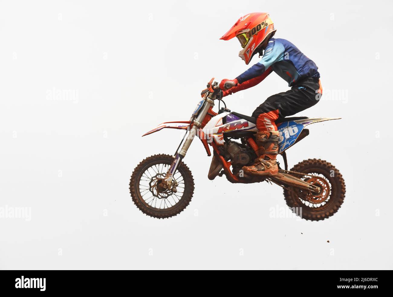 Young teenager during a motorcycle race - Jump, extreme sport Stock Photo