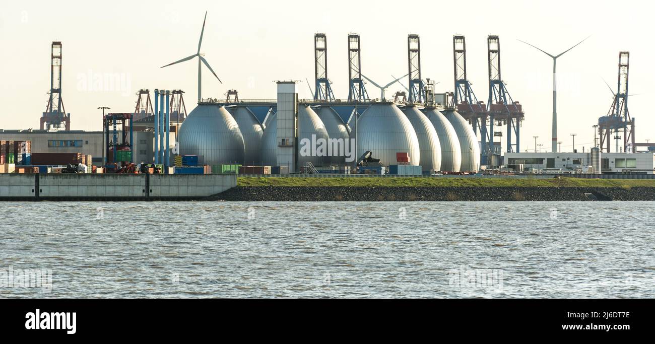 Gas storage reservoir, wind turbines and cranes in the harbour area in Hamburg, Germany Stock Photo