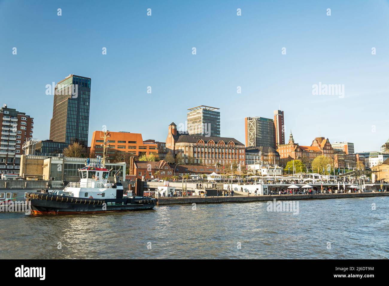 Waterfront and tugboat at the famous pier at St. Pauli Landungsbrücken in Hamburg, Germany Stock Photo