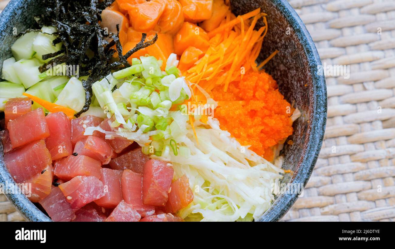 Close up of Hawaiian dish poke bowl with diced raw salmon and tuna Stock Photo