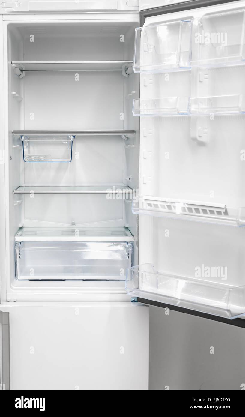 Opened empty refrigerator. Refrigerator open empty fridge inside interior. close up on empty freezer with door open. New clean refrigerator. Empty ope Stock Photo
