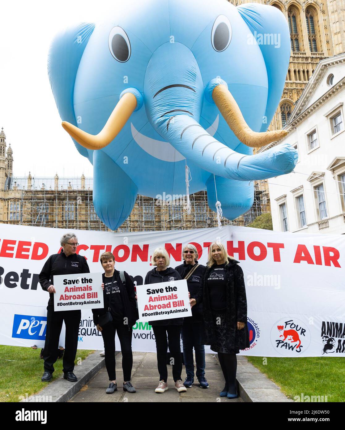 April 27, 2022, London, United Kingdom: Protestors hold placards supporting animal rights on Parliament Square during a protest in College Green. Animal rights activists erected two large inflatable balloons in the shape of a lion and an elephant in support of the Animal Protection Bill that is currently before Parliament. The bill would ban the imports of Foie Gras as well as hunting trophies, and the promotion of elephant tourist rides overseas (Credit Image: © Tejas Sandhu/SOPA Images via ZUMA Press Wire) Stock Photo