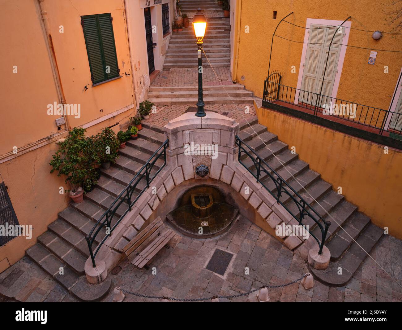 AERIAL VIEW from a 6-meter mast. Charming staircase with a small fountain in the Old Town of Villefranche-sur-Mer. French Riviera, France. Stock Photo