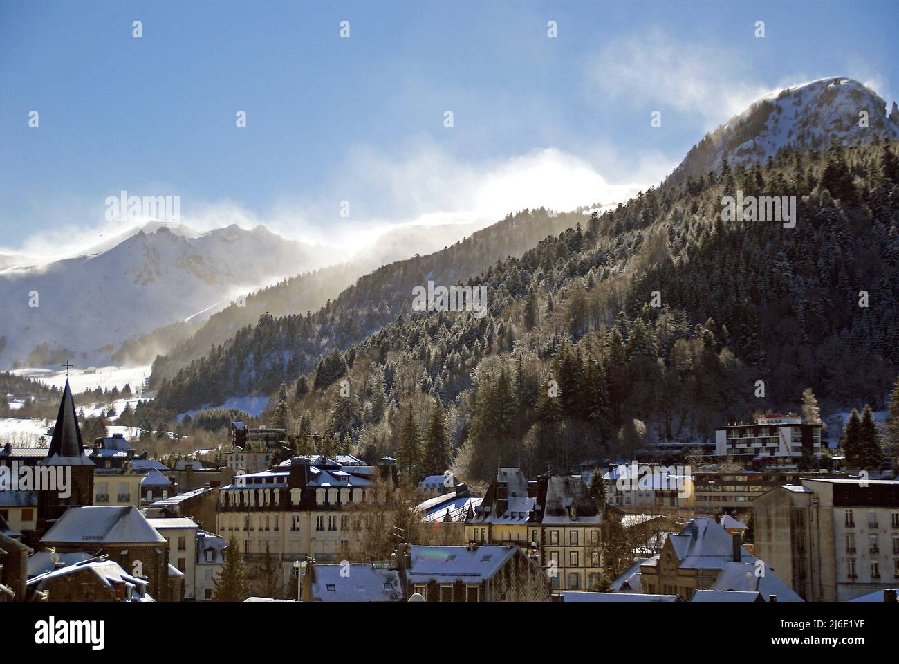 The town of Mont-Dore, with blown snow over the Massif de Sancy Stock Photo