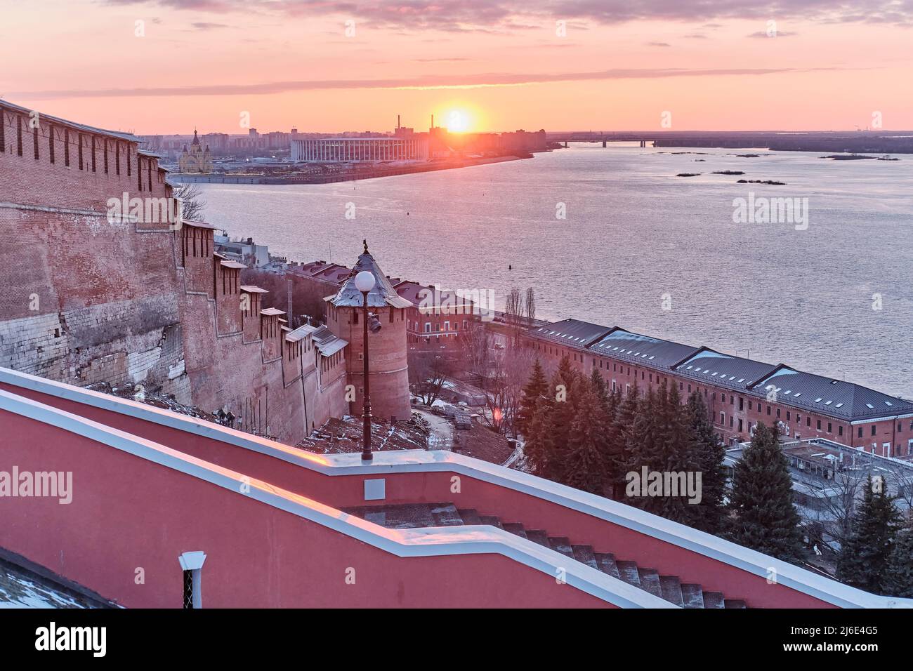 Walls of ancient Nizhny Novgorod Kremlin, famous Chkalov Stairs, Volga River during sunset. Stock Photo