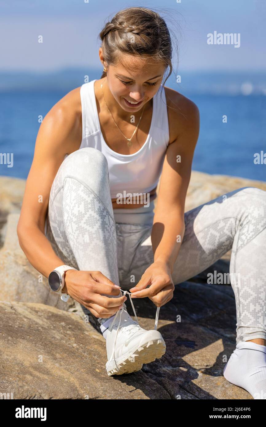 Athletic Woman Wearing Shoes During Outdoor Workout Stock Photo