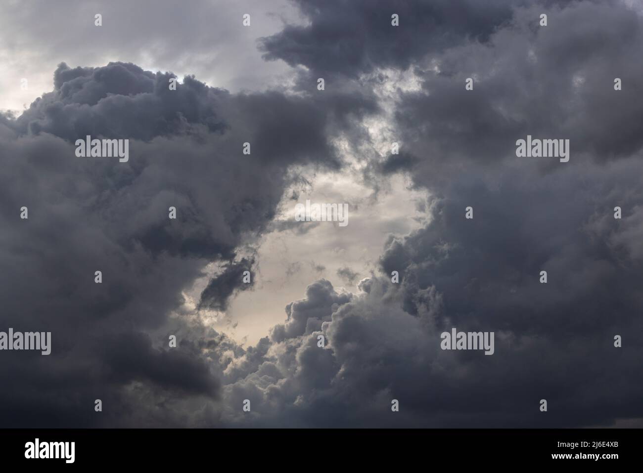 Dark storm clouds opening light hi-res stock photography and images - Alamy