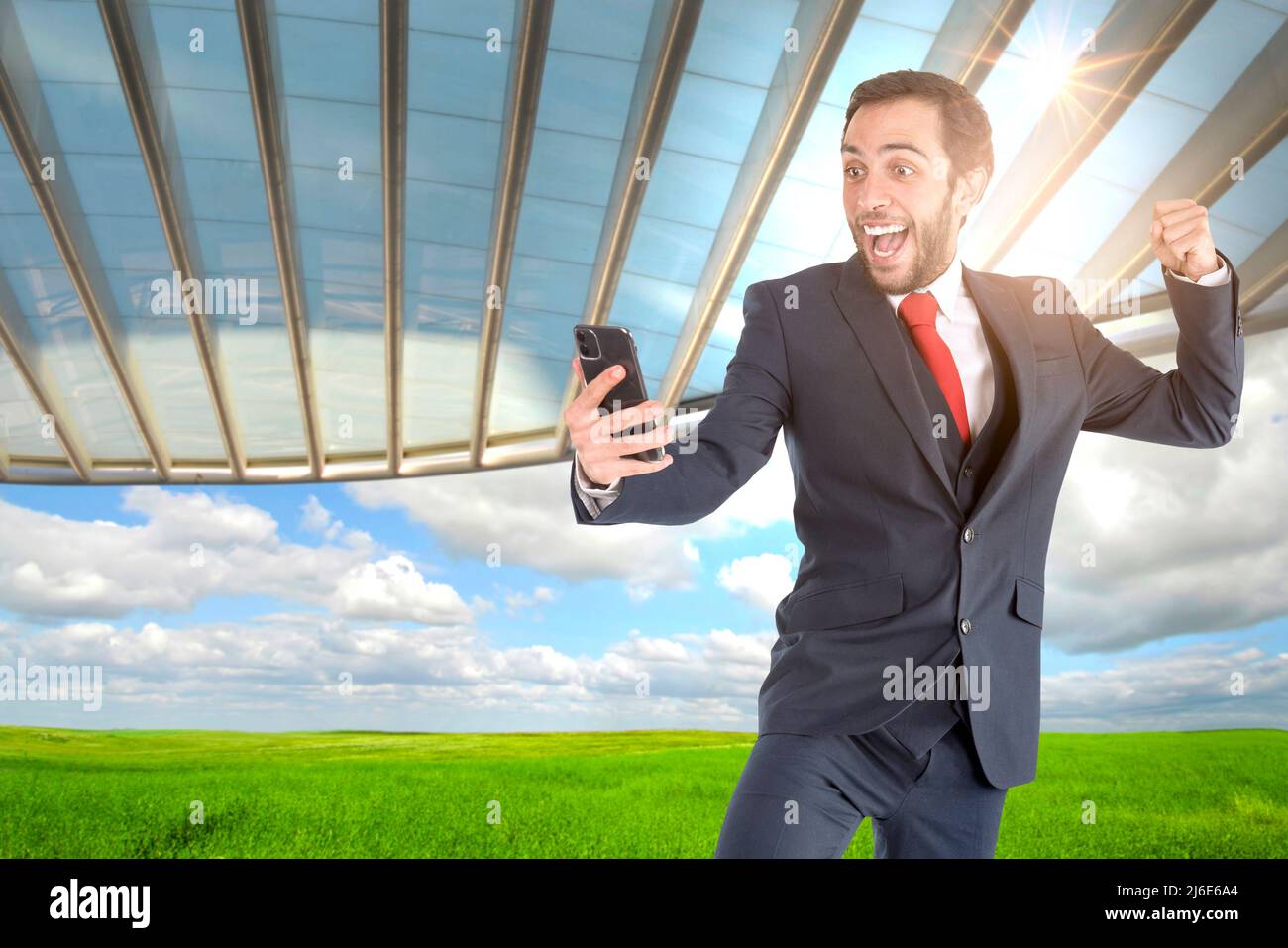 Happy businessman or stock broker with mobile phone outdoors Stock Photo