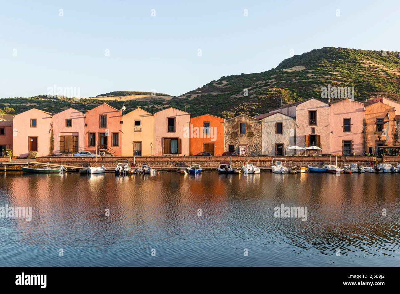 Picturesque Bosa - colourful historic tanner's houses in a row on the waterfront of the Temo in the old town glow in the sun, Planargia, Sardinia Stock Photo