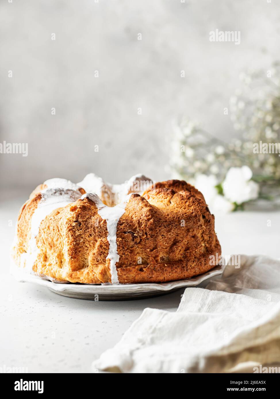 Icing Mess Beautiful fluffy bundt cake decorated with icing. Still life with linen ...