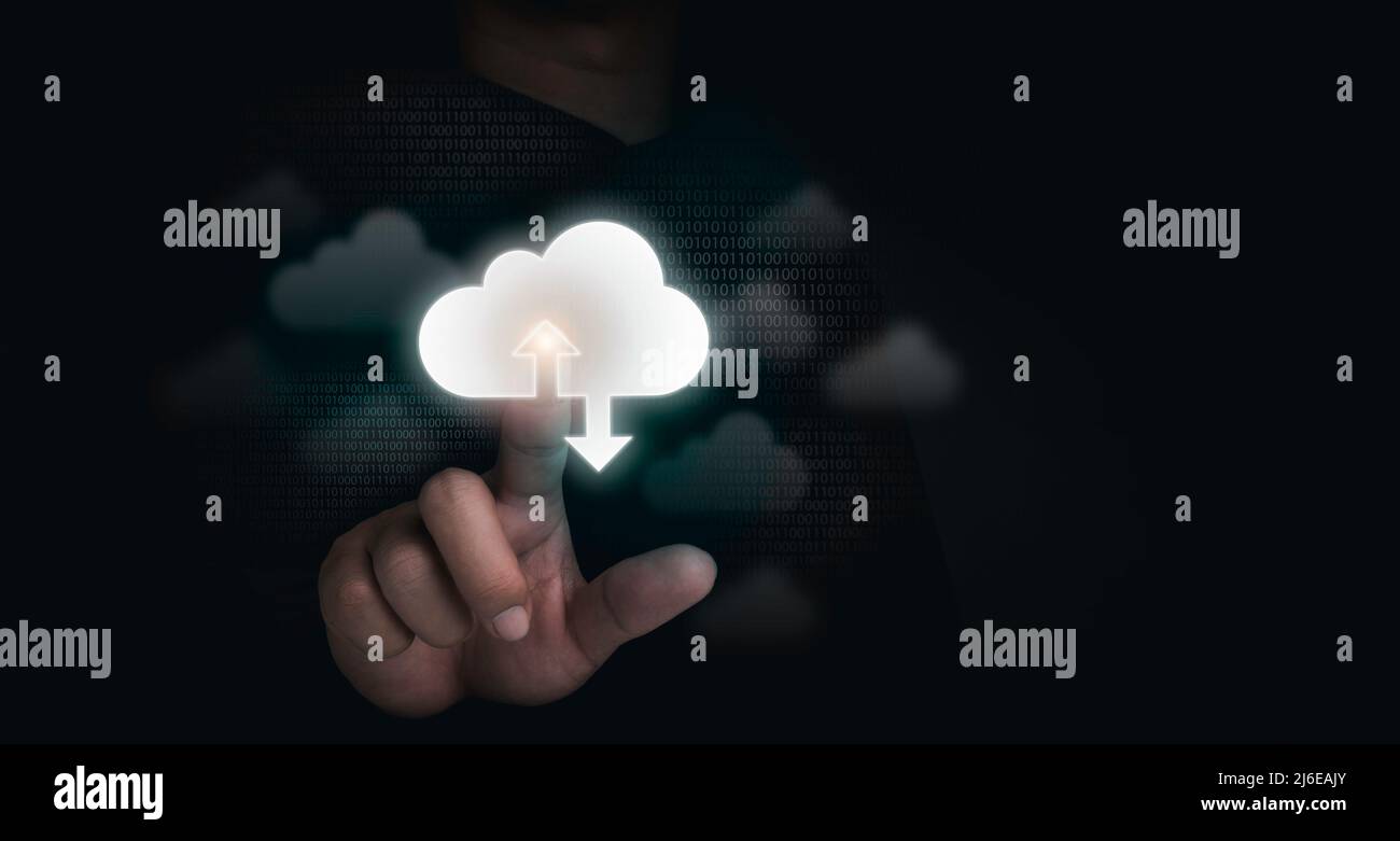 Cloud storage concept. Cloud computing technology, virtual icons touched by a businessman with binary code on dark background with copy space. Busines Stock Photo