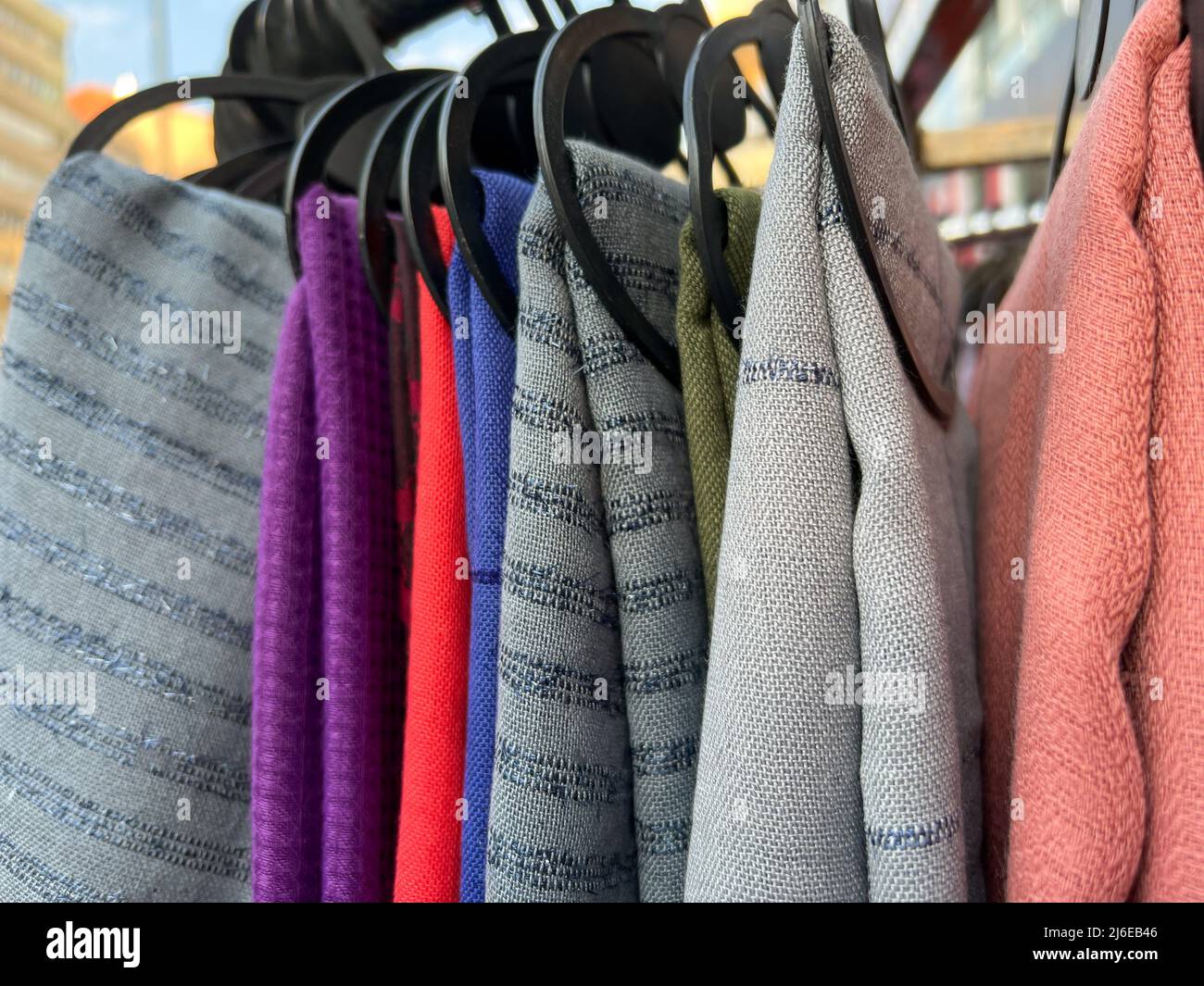 scarf, colorful trendy and fashionable scarves hanging on rack in a cloth store. fashion concept photo with selective focus Stock Photo
