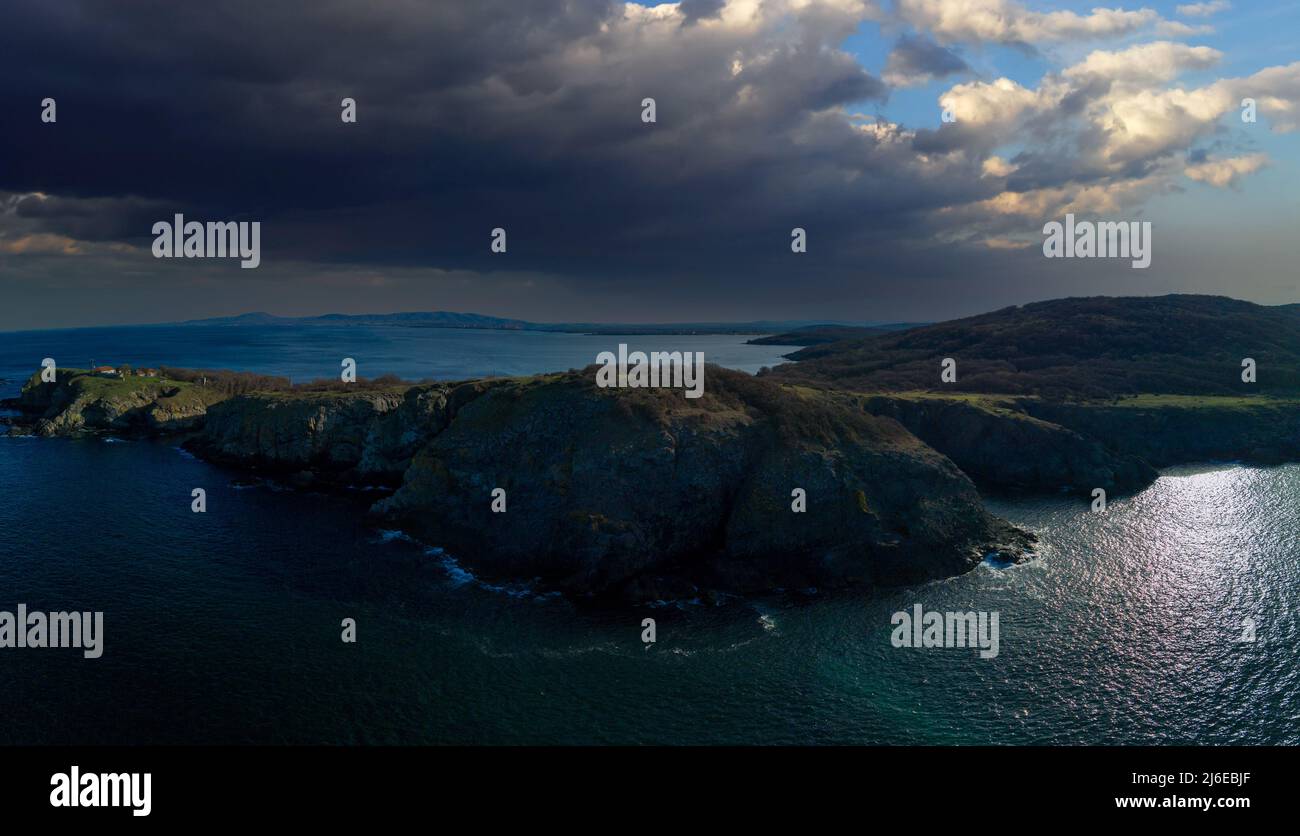 Bird's eye view panorama of rocky green wild ledge with wet large sharp ...