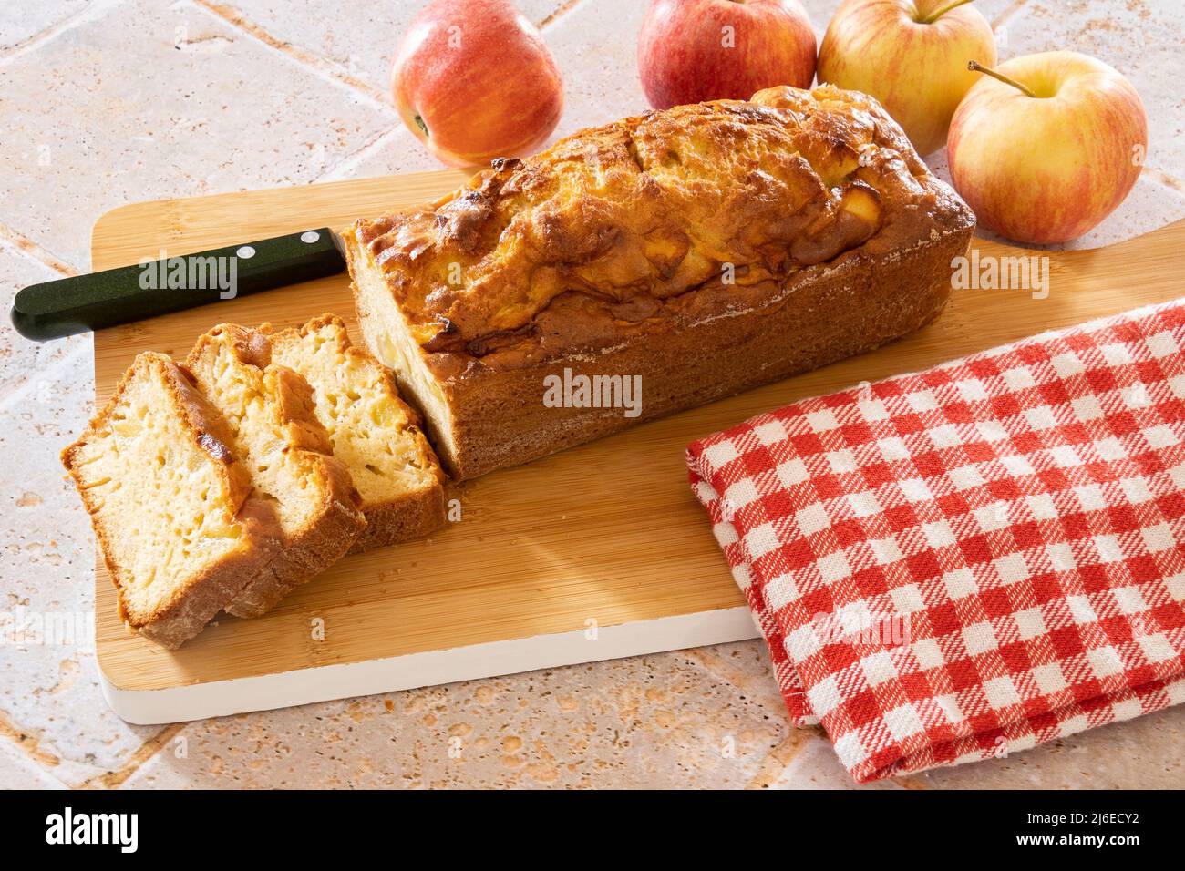 a cut apple cake on a wooden board Stock Photo