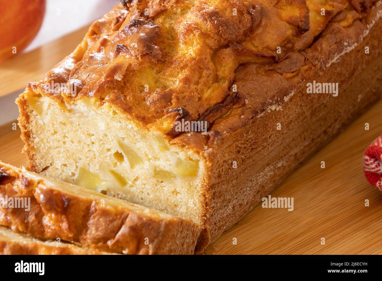 a cut apple cake on a wooden board Stock Photo