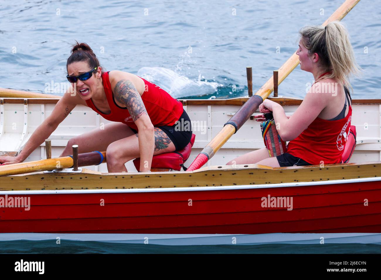 A woman from the Roseland Gig Rowing Club reacts after finishing Ladies