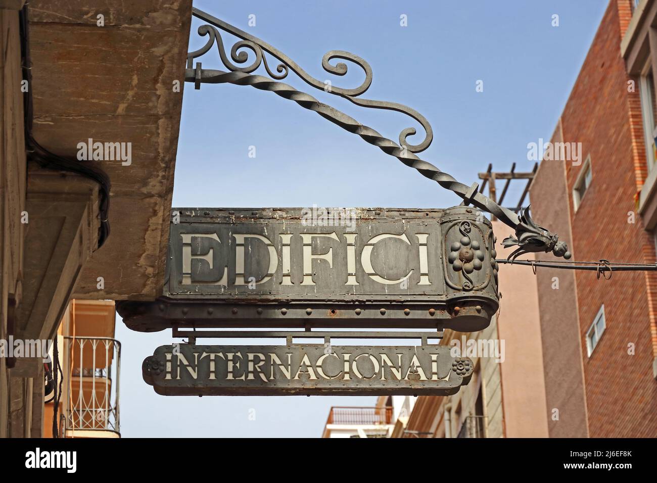 Old metal sign 'Edifici International' over street in Reus Stock Photo