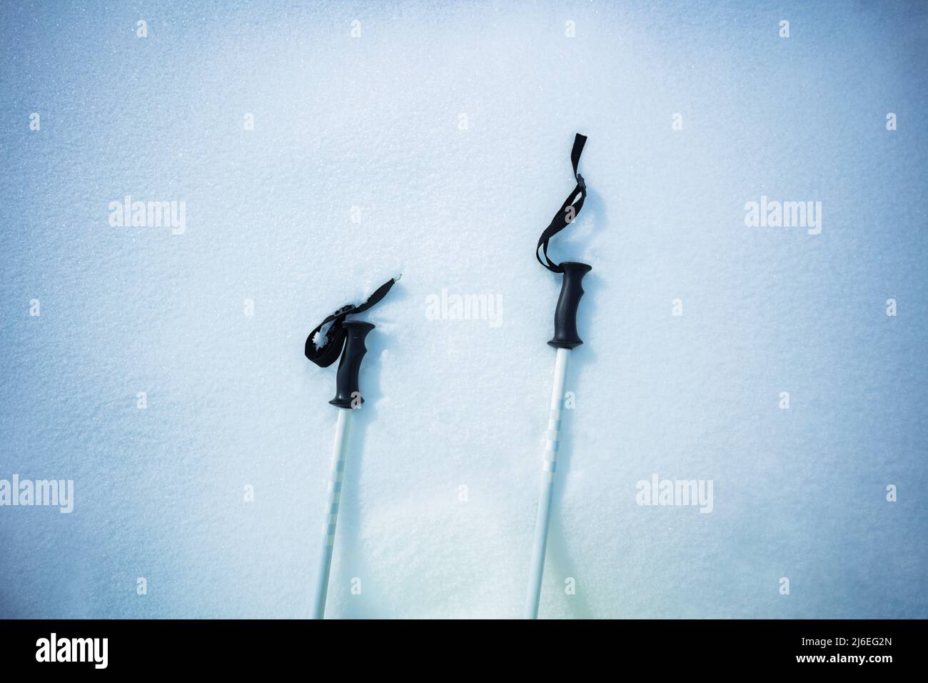 Details shot of a mountain ski poles pair in the snow from above Stock Photo