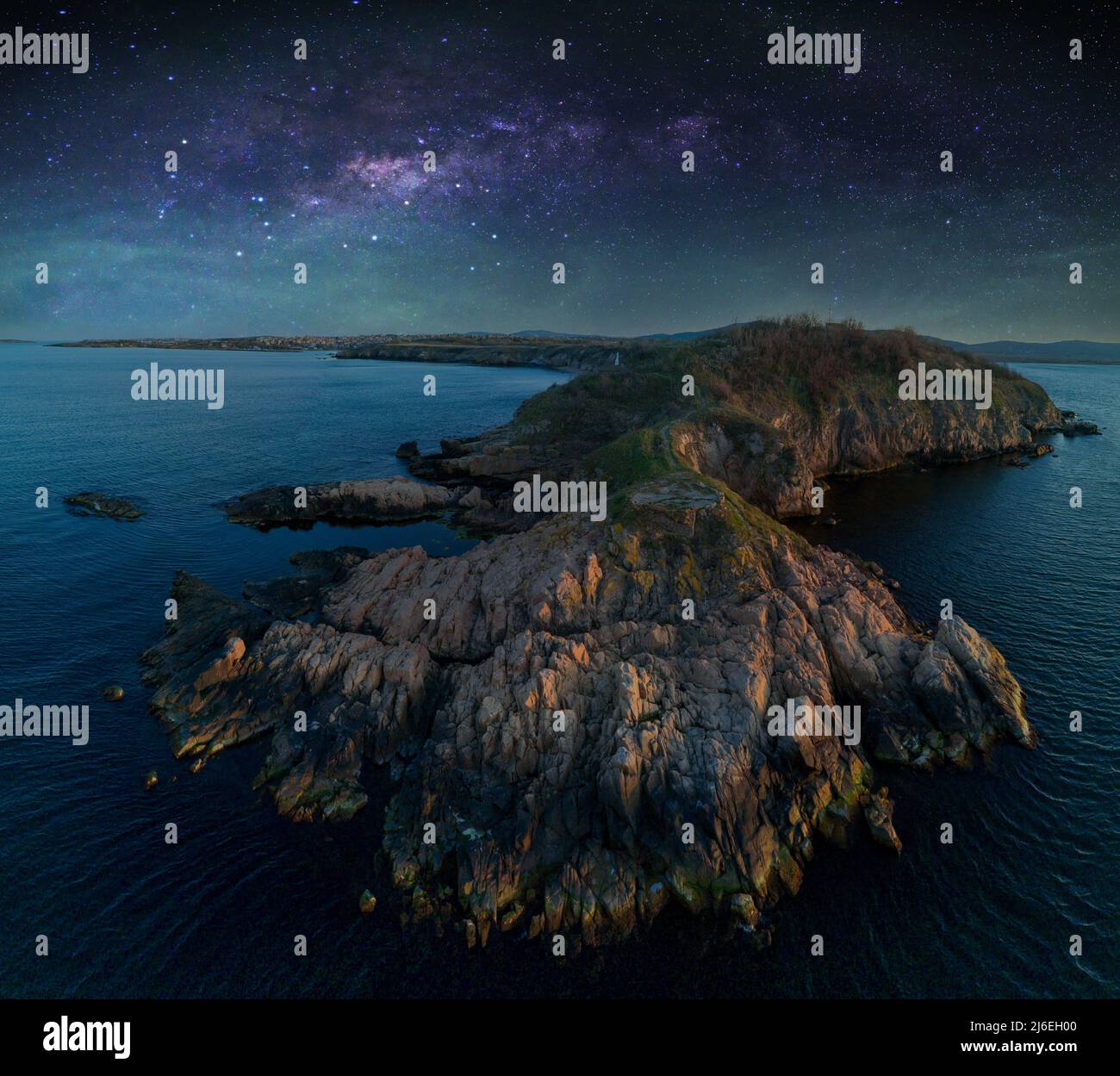 Bird's eye view panorama of rocky green wild ledge with wet large sharp ...