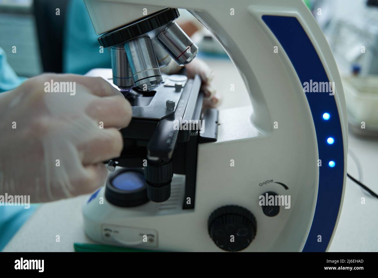 Woman is using microscope in medical laboratory Stock Photo - Alamy