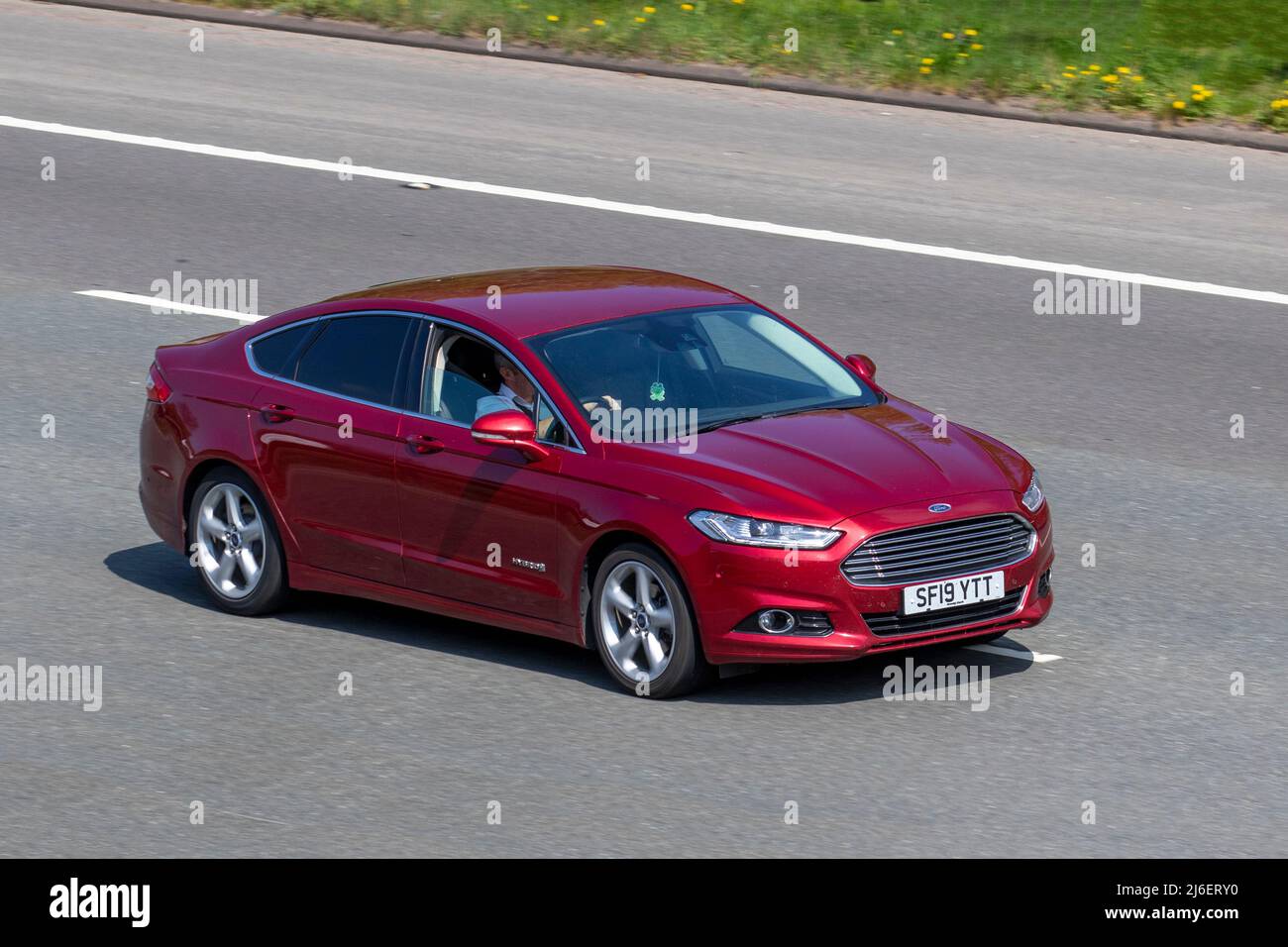 2019 red Ford Mondeo Titanium Edition HEV 1999cc 6 speed automatic 4dr saloon; driving on the M61 motorway, UK Stock Photo