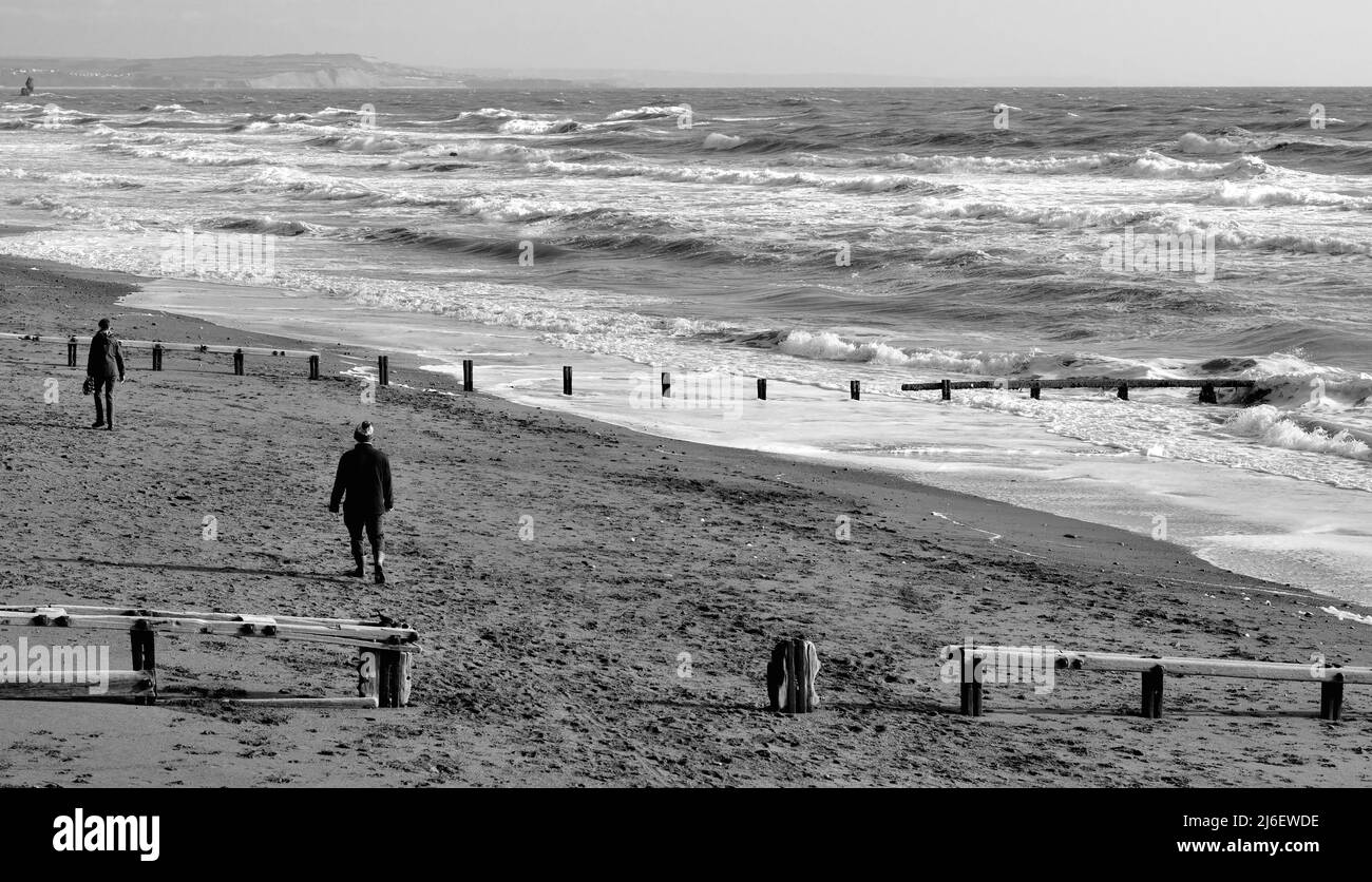 People walking on the beach at low tide, Teignmouth, South Devon. Stock Photo