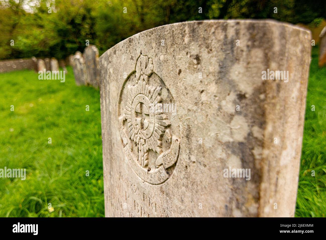 Close up of a Commonwealth War Grave headstone bearing the Royal Sussex Regiment Crest / Emblem - Findon, West Sussex, UK. Stock Photo