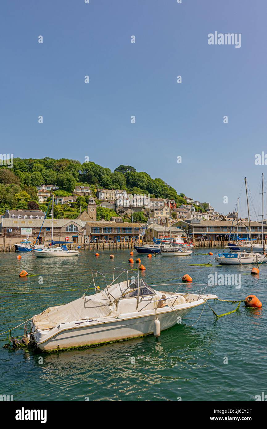 Looking over the East Looe River at high tide to East Looe and its hillside buildings and waterfront, on a hot July day - Looe, Cornwall, UK. Stock Photo