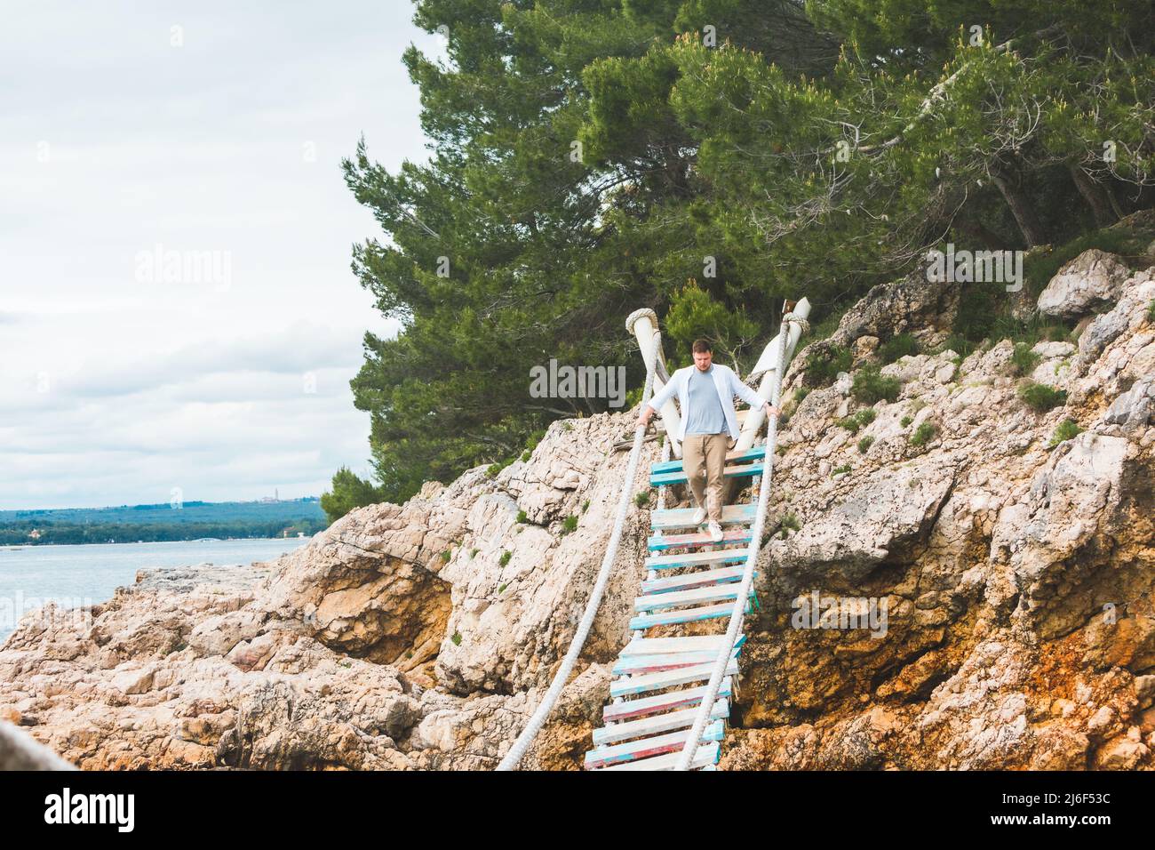 man walking by suspension bridge cross adriatic sea summer time Stock ...