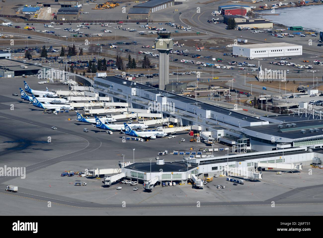 Ted Stevens Anchorage International Airport passengers terminal in Alaska. Multiple airplanes of Alaska Airlines together at Anchorage Airport. Stock Photo
