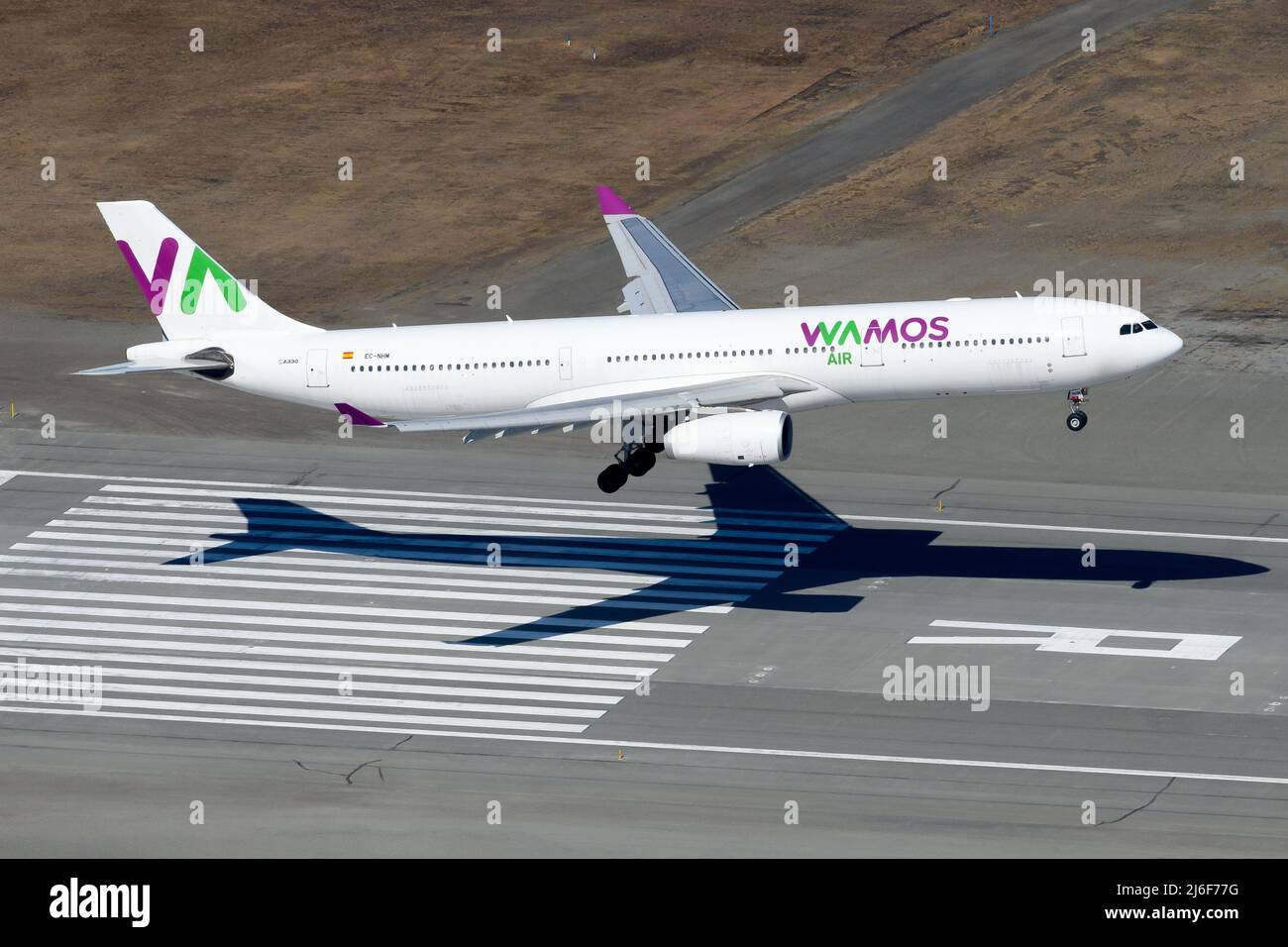 Wamos Air Airbus A330-300 airplane landing. Aircraft A330 of charter airline WamosAir. Plane registered as EC-NHM. Stock Photo