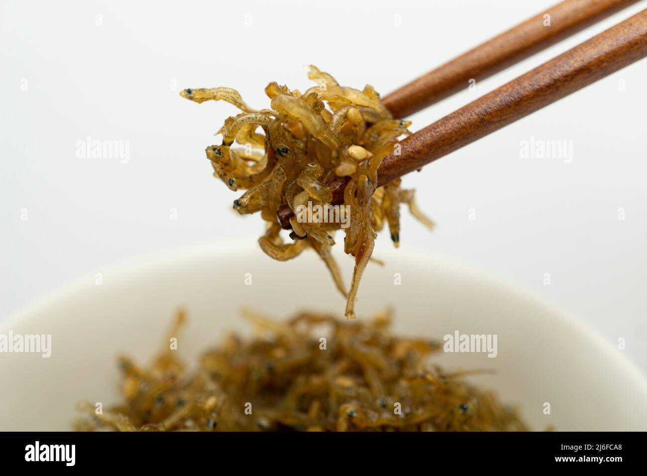 Savory stir-fried anchovies in a bowl Stock Photo - Alamy