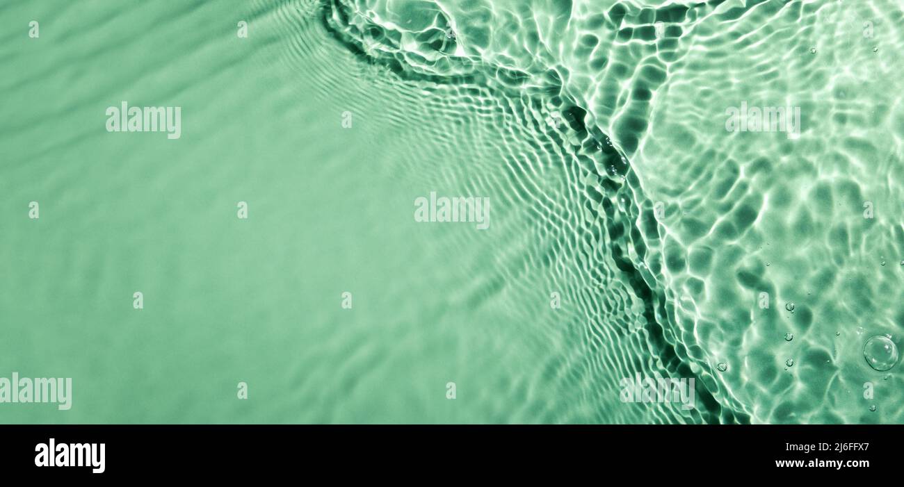fresh water wave surface texture on green background with copy space. hydration and moisturizer. banner Stock Photo