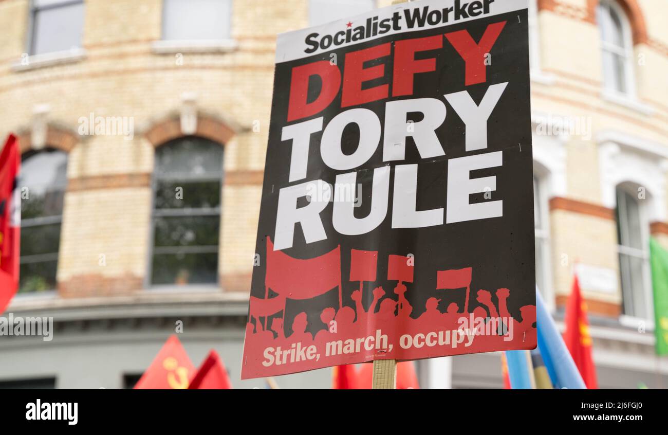 London UK 01 May 2022. Celebrating International Workers Day, Trade Union members and protesters march to central London finishing with a Rally in Trafalgar Square. Defy Tory Rule banner . Organised by London Trade Union Councils Credit: glosszoom/Alamy Live News Stock Photo