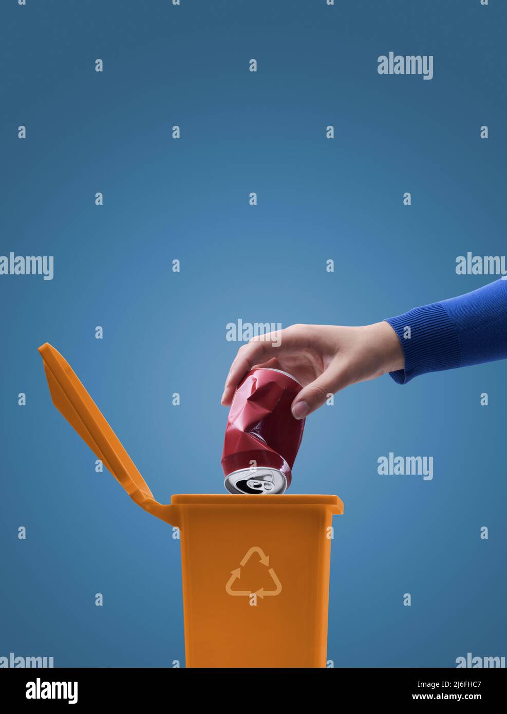 Woman putting a crushed can in the trash bin, separate waste collection