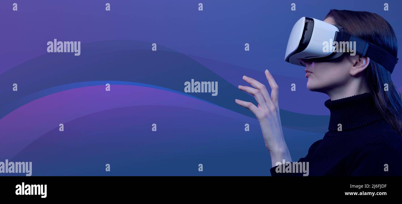 Woman wearing a VR headset and interacting with virtual reality ...