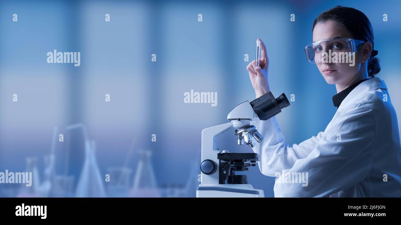 Young scientist using a microscope hi-res stock photography and images ...