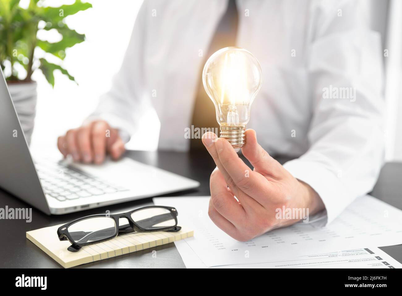 Business, creative idea concept. Businessman holding light bulb Stock Photo