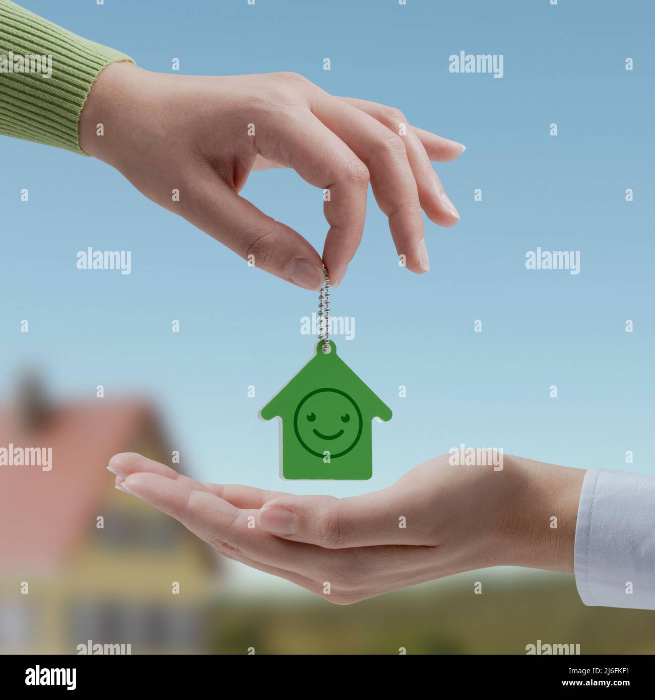 Real estate agent giving house keys to the buyer, successful property