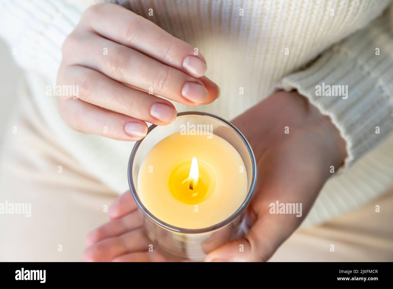 Heat from a candle on a woman's palm Stock Photo Alamy