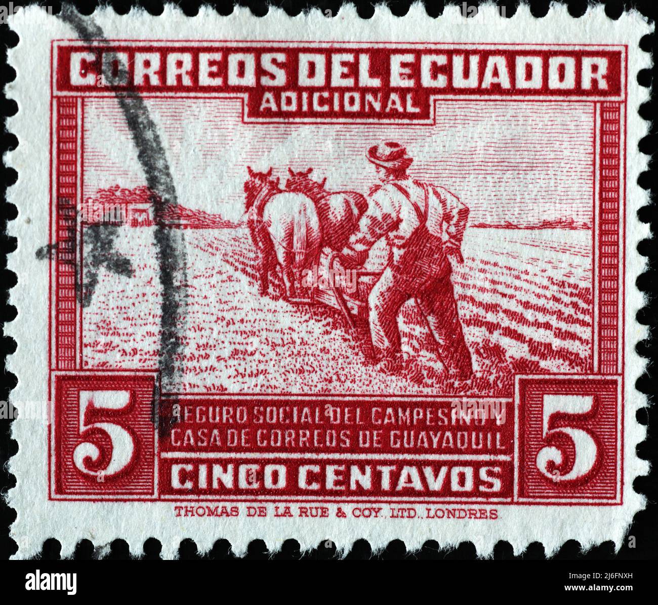 Farmer plowing a field on vintage postage stamp of Ecuador Stock Photo
