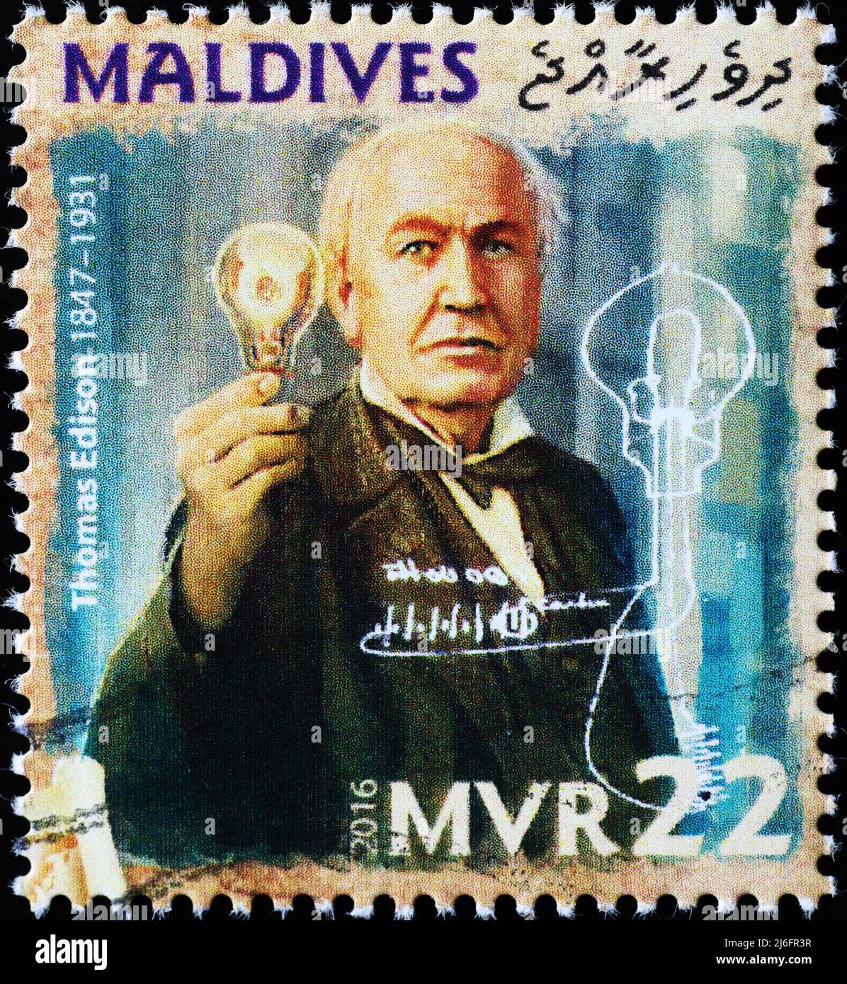 Thomas Edison showing his lamp on postage stamp Stock Photo