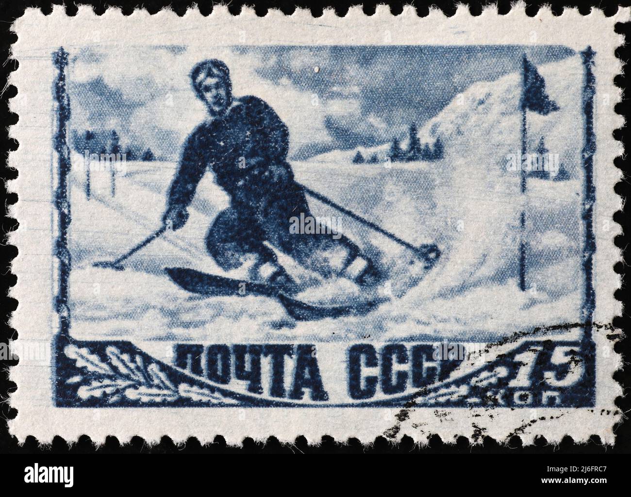 Vintage skier on old russian postage stamp Stock Photo