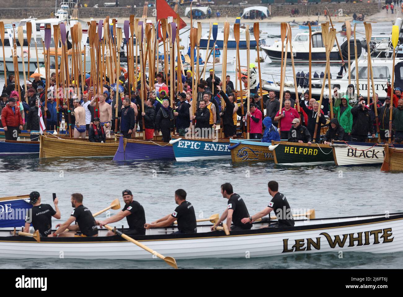 Rowers stand on rafted-up boats during the World Pilot Gig rowing Championships, in the Isles of Scilly, Britain, May 1, 2022. REUTERS/Tom Nicholson Stock Photo