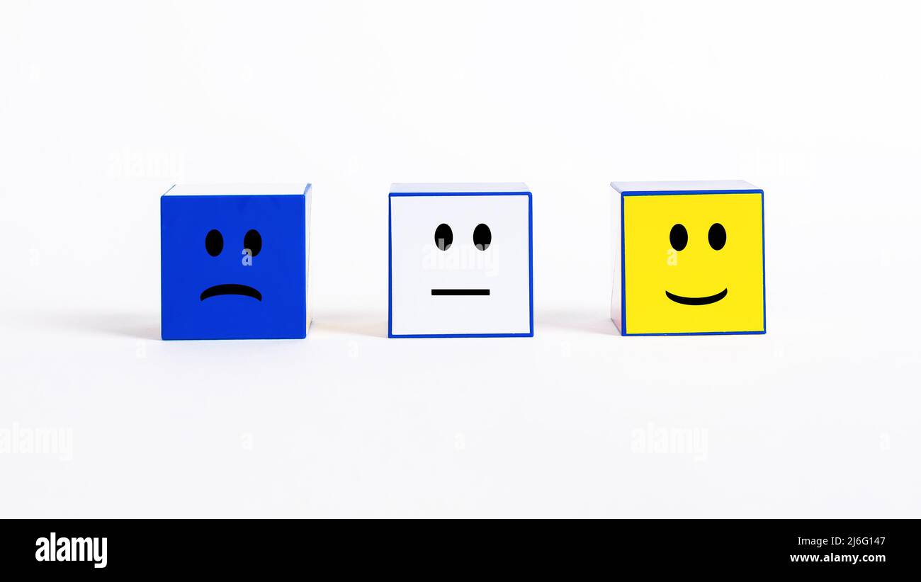 Customer satisfaction rating and feedback. Cubes with sad and smiley emotions. Negative, neutral and positive visitors or clients mood. Conducting survey to evaluate service quality. photo Stock Photo