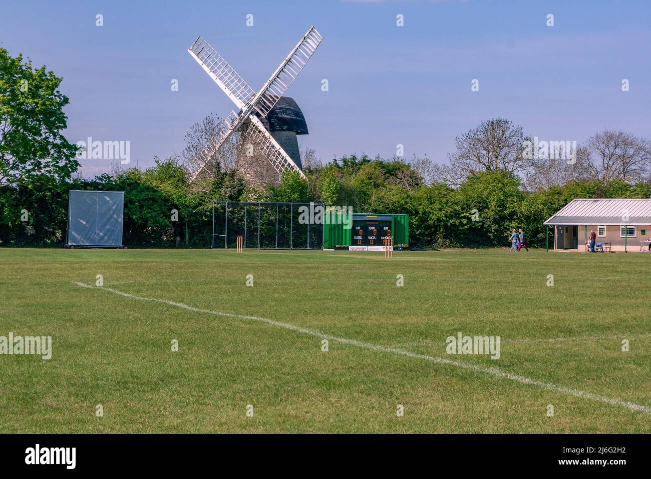 New Bradwell. Milton Keynes, UK, April,24,2022: New Bradwell cricket ground with New Bradwell Windmill in the background Stock Photo