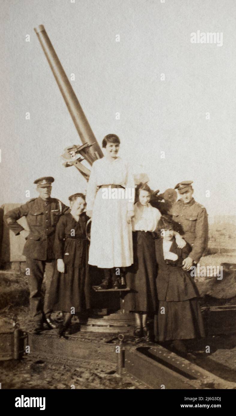 A British 3 inch anti-aircraft gun with a group of women and two Royal Artillery Gunners posing, taken about the end of the First World War. Stock Photo