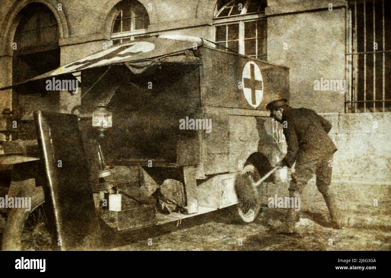 A British Red Cross Society ambulance being cleaned by a soldier during the First World War. Stock Photo