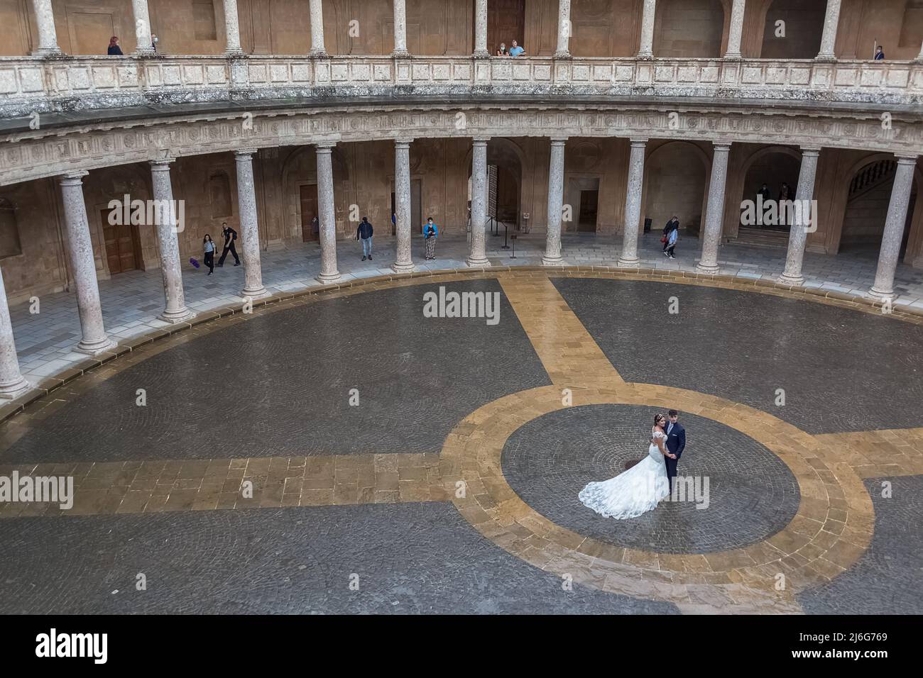 Granada Spain - 09 14 2021: Interior circular Patio on Charles V Palace, wedding couple taking pictures on center at the Patio, Renaissance building l Stock Photo